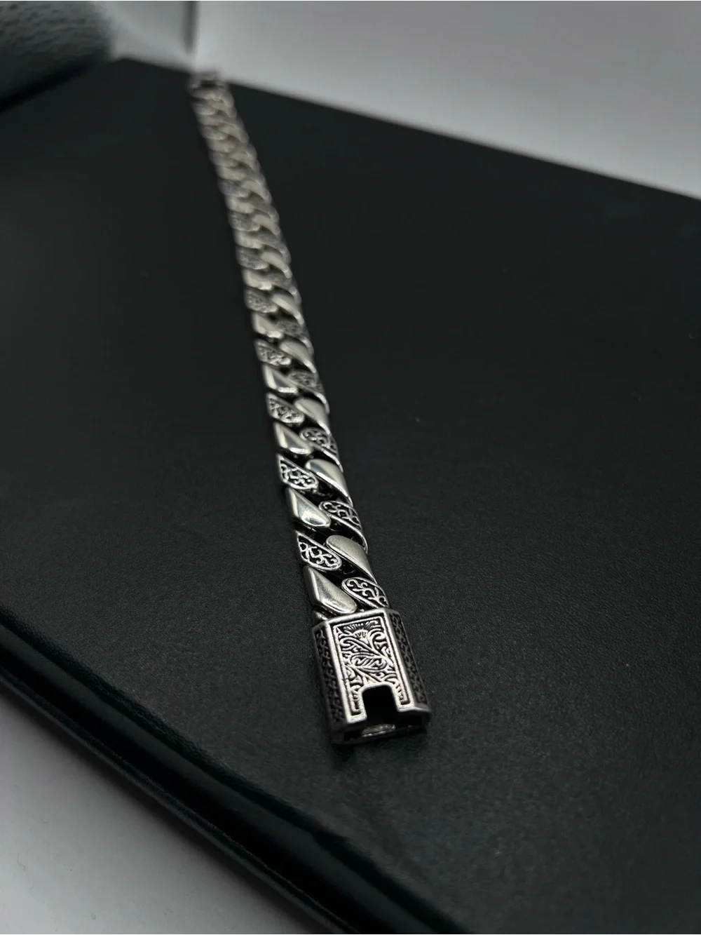 Engraved Cuban Link Bracelet with a secure clasp closure